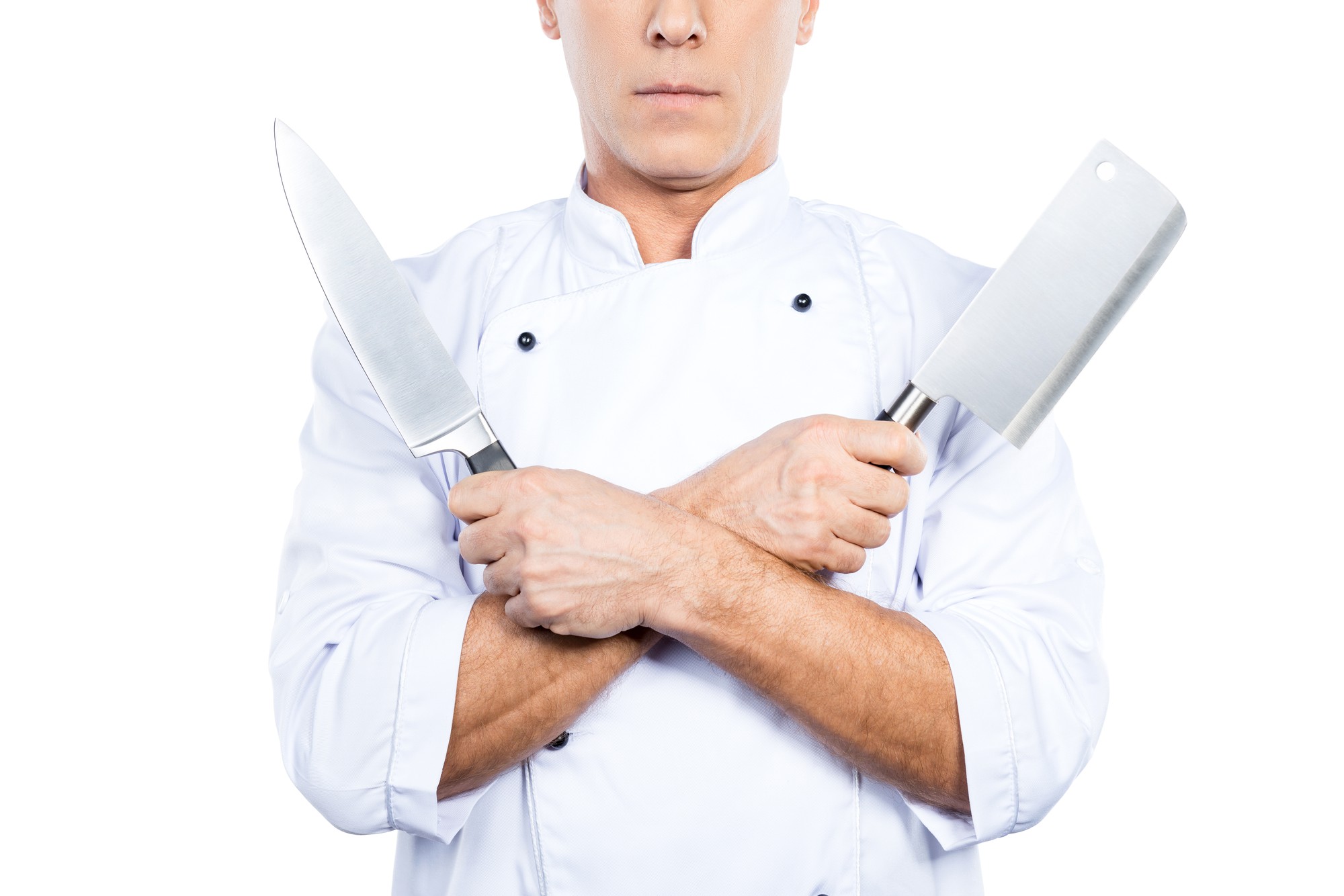 Chef demonstrating knife skills over wooden board